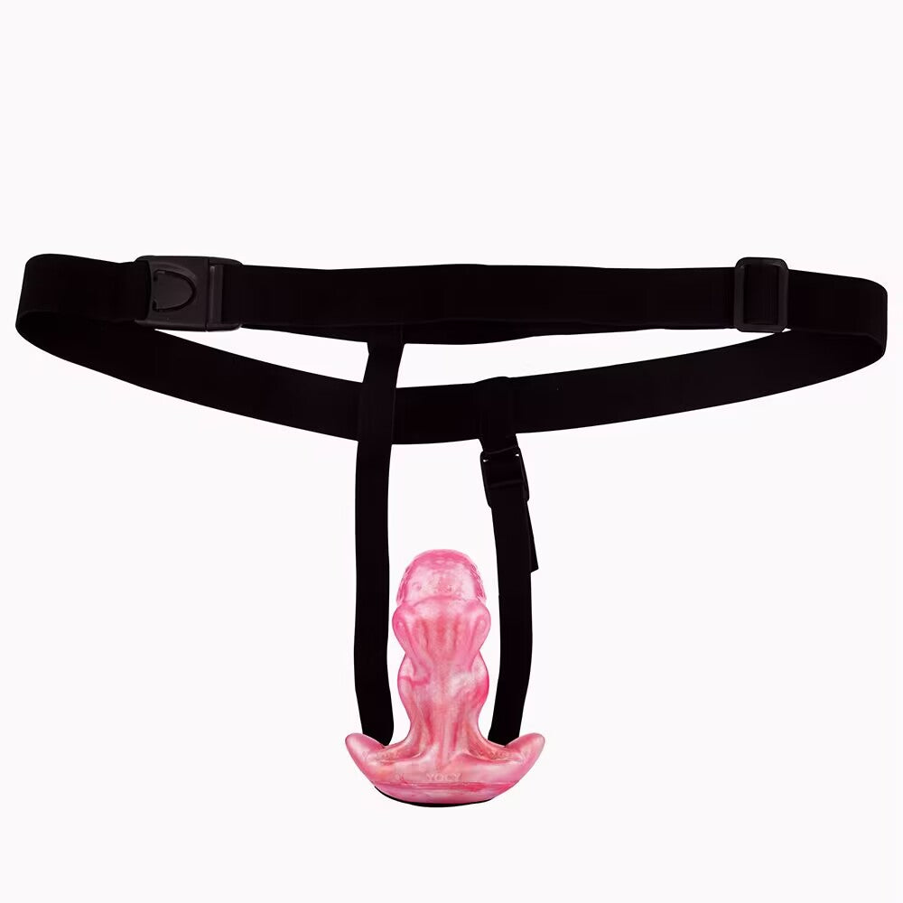 Pink octopus fantasy dildo mounted onto a black elastic body harness viewed from the front.