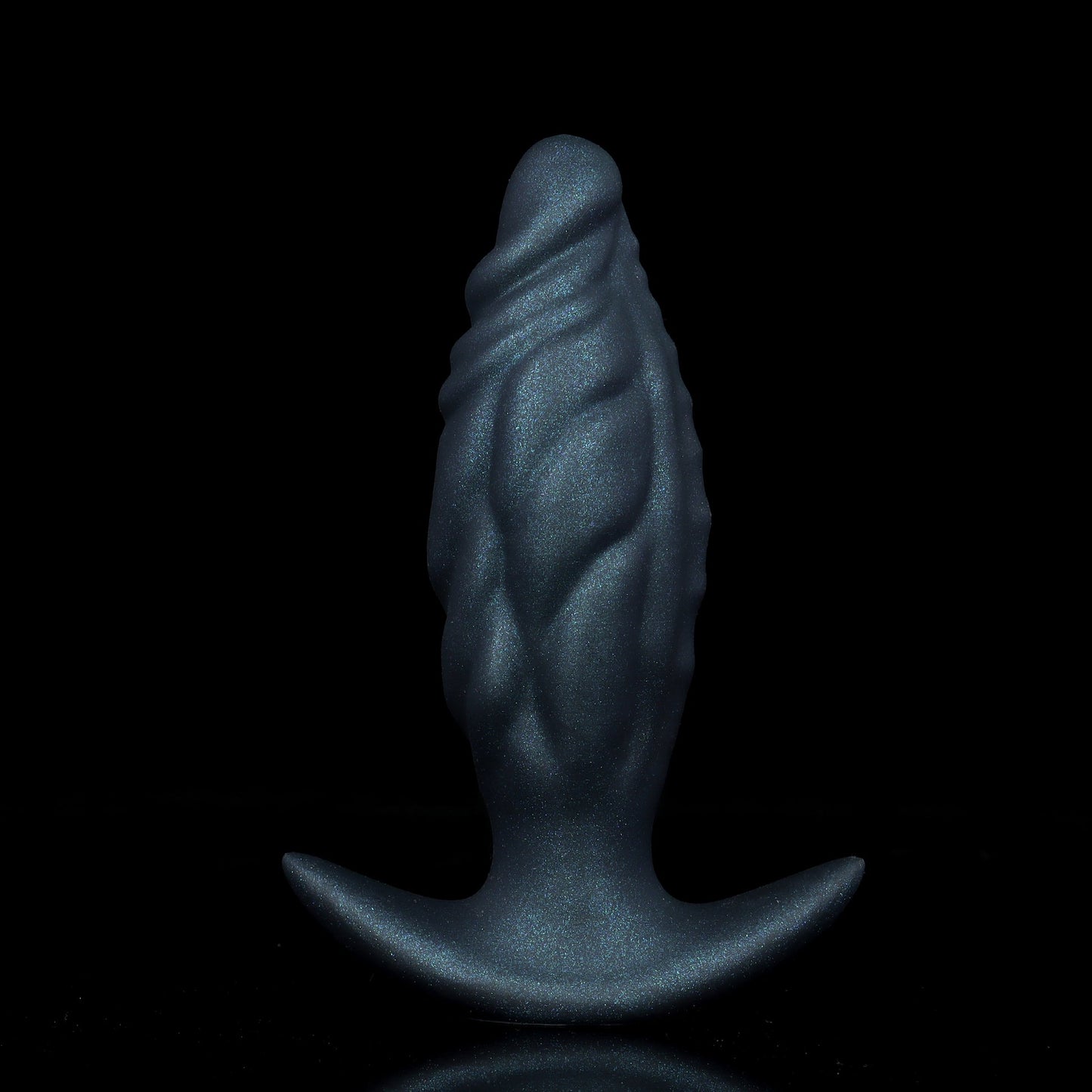 Onyx black textured ripple core anal plug with a subtle glitter finish, standing on a reflective black background surface.