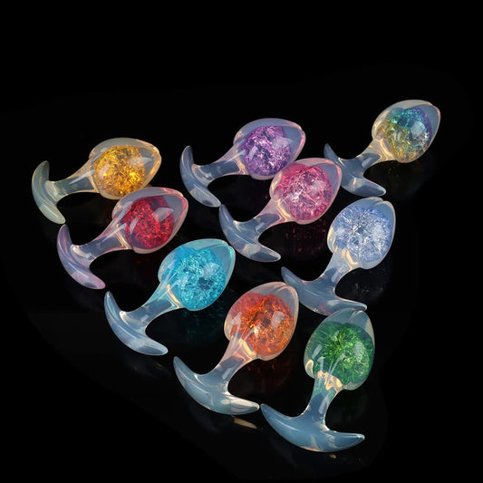 A stunning triangular display of multi-colored aesthetic plugs featuring a semi-translucent opaline T-bar base and a vibrant crackle-effect core in orange, blue, red, purple, and green.