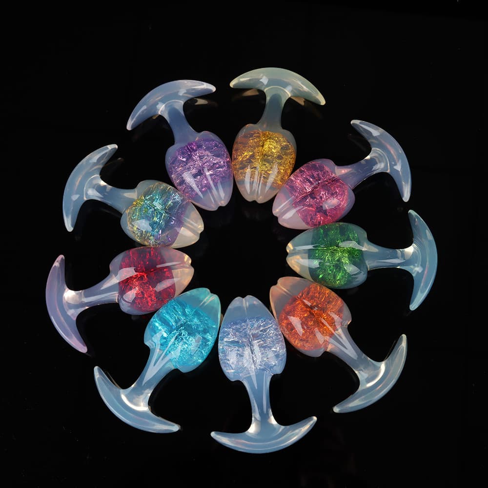 A beautiful circular wheel arrangement of ten opal-glowing crackle-core plugs in a spectrum of vibrant artistic colors on a dark background.