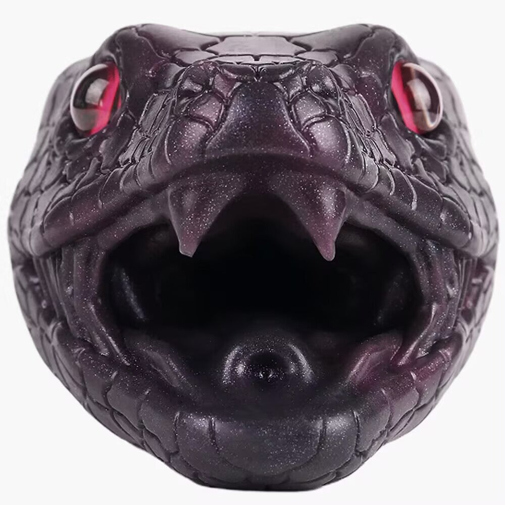 Close-up of open-mouth venomous snake head showing fangs and entry hole for fantasy stroker