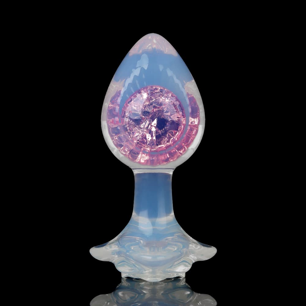 Symmetrical front shot of a translucent glass plug highlighting a pastel pink crystal ball core