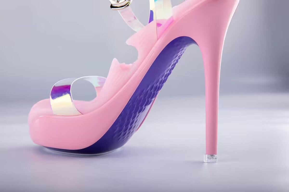 Side profile of pink high heel stroker sleeve featuring a textured purple sole and clear strap