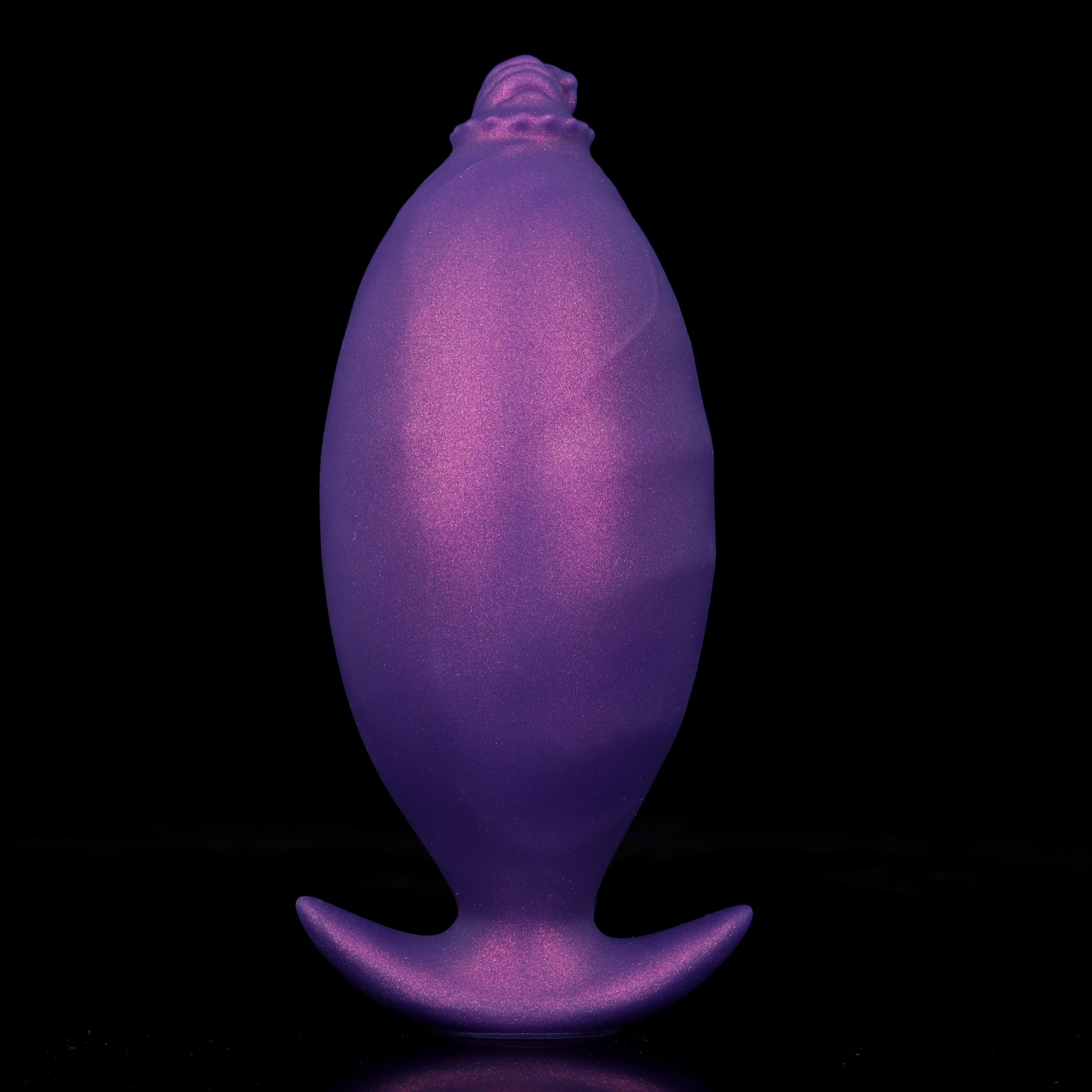 A fully inflated purple silicone fantasy butt plug showing a massive ballooned shape and smooth expanded texture for ultimate fullness.