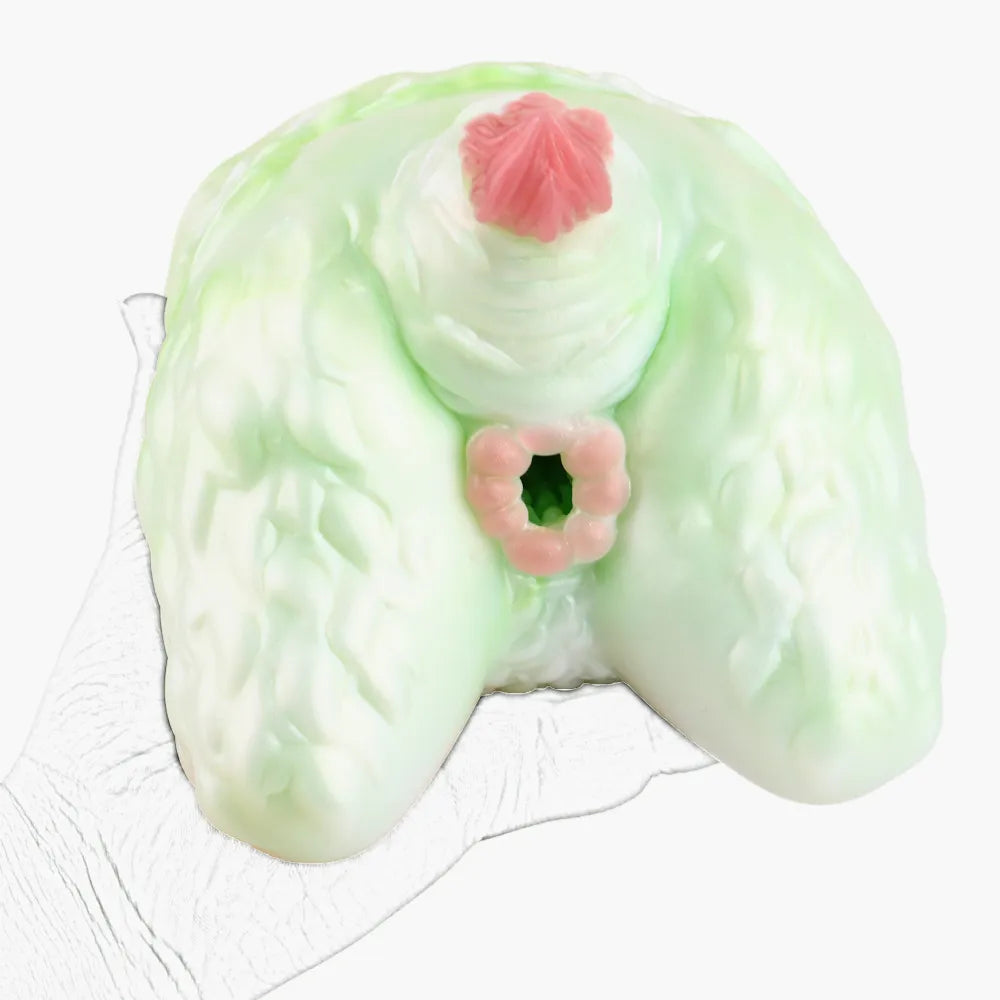 A hand holding the furry monster stroker toy to demonstrate its large, heavy size and shape.