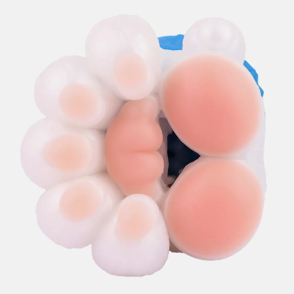 Top-down close-up view of the white and pink plush-like TPE beast paw pad entrance of the male stroker toy.