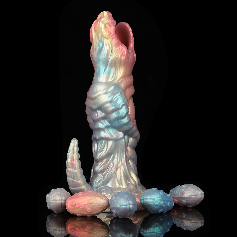 Side view of a standing sci-fi xenomorph egg layer dildo with a pearlescent finish, surrounded by textured silicone eggs at its base against a black background.