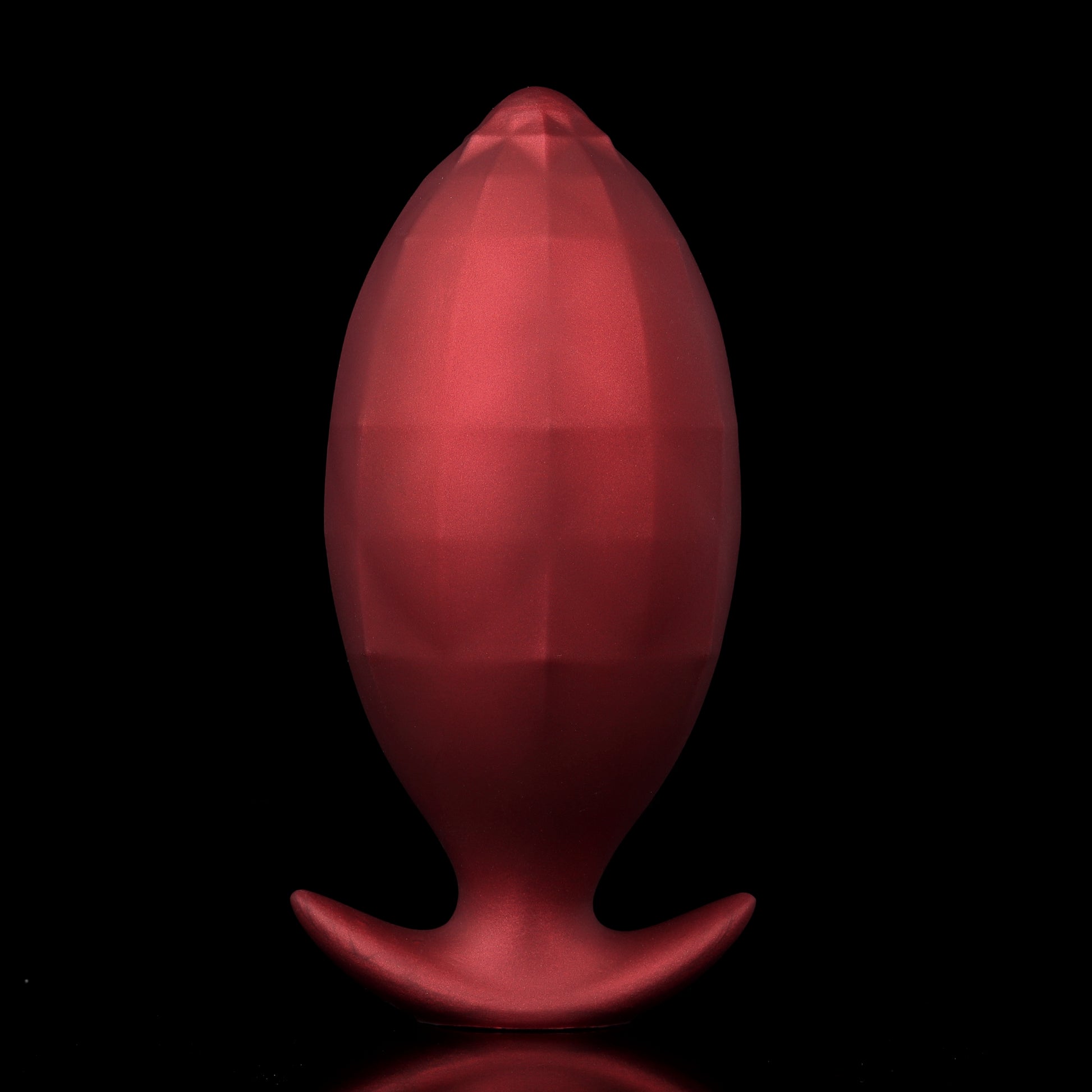 Front view of a smooth, egg-shaped crimson red inflatable silicone plug, highlighting its flawless surface and secure crescent anchor base.