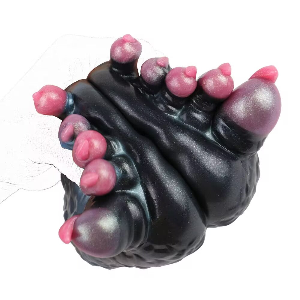 Hand squeezing soft silicone monster paw toy demonstrating ergonomics and grip.