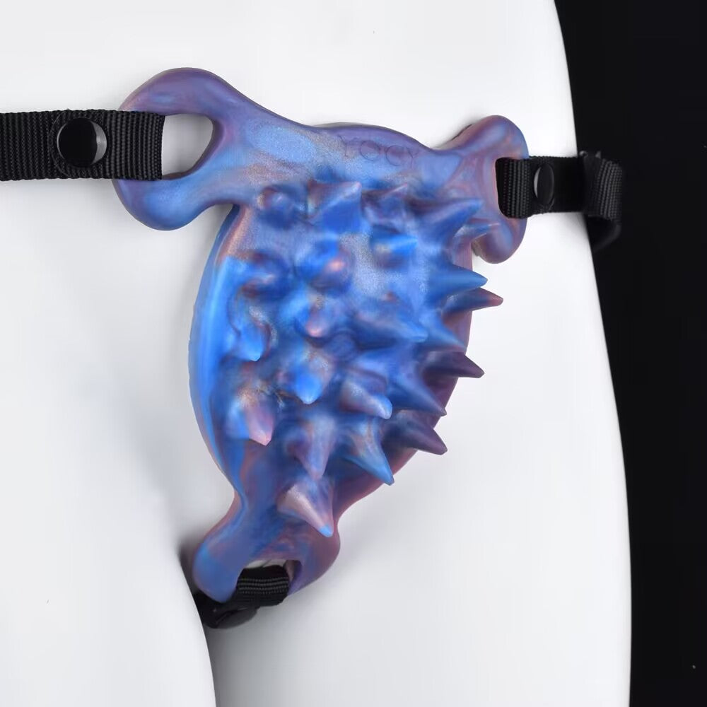 Side view of spiked silicone friction pad with adjustable black nylon harness strap