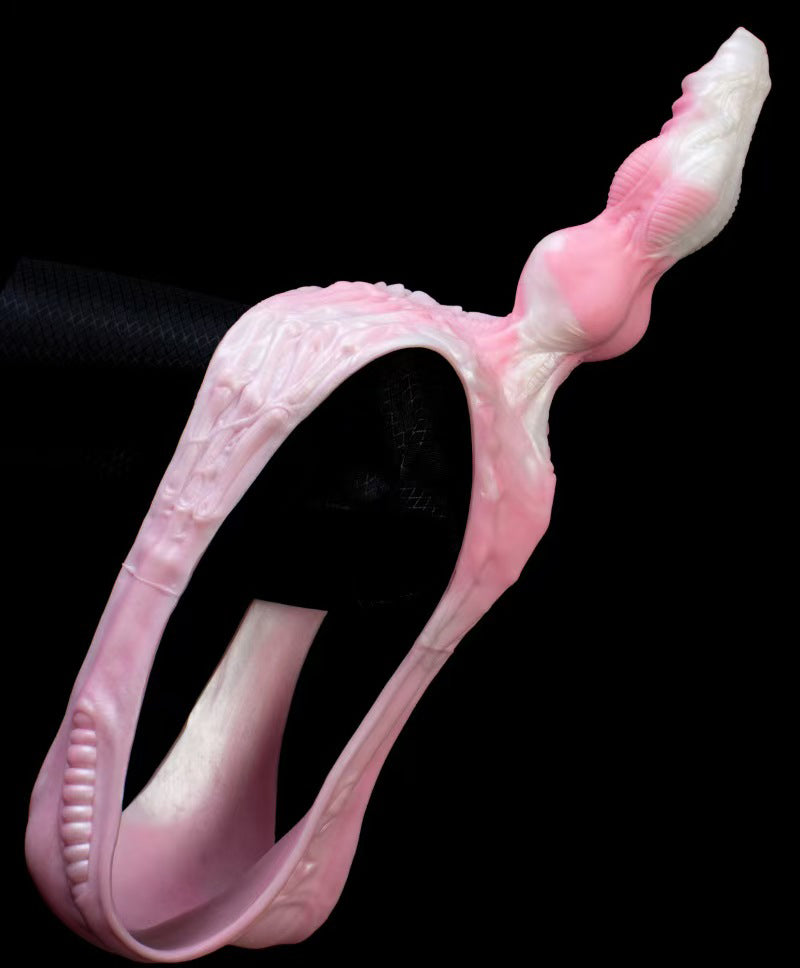 Full product view of the pink integrated silicone wearable panty dildo with detailed biomechanical spine textures and a tapered creature head.