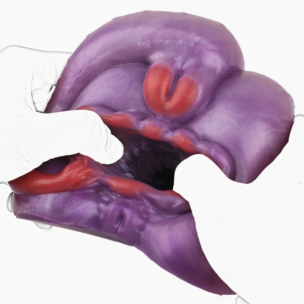 Demonstration of the hyper-elasticity and flexibility of the purple fantasy alien sex toy being pulled apart to reveal the inner ribbed chambers.