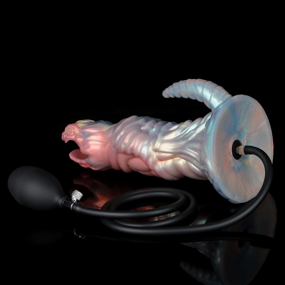 Close-up of the wide suction cup base of an oviposition monster dildo, displaying the black inflation hose connected into the center channel for egg laying simulation.