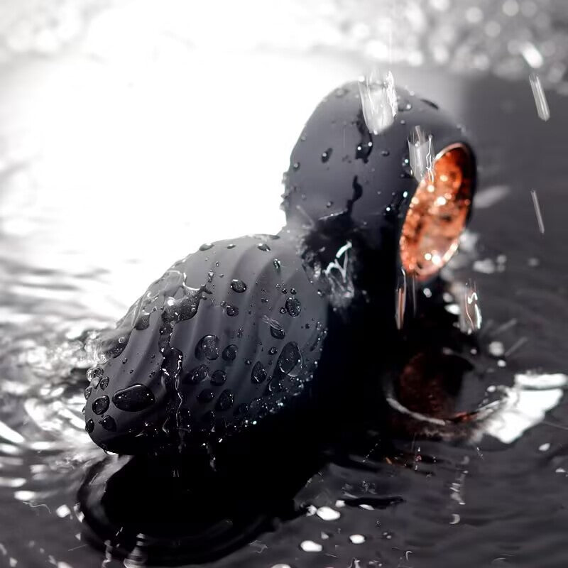 Fully waterproof black silicone vibrating plug covered in water droplets for safe shower play