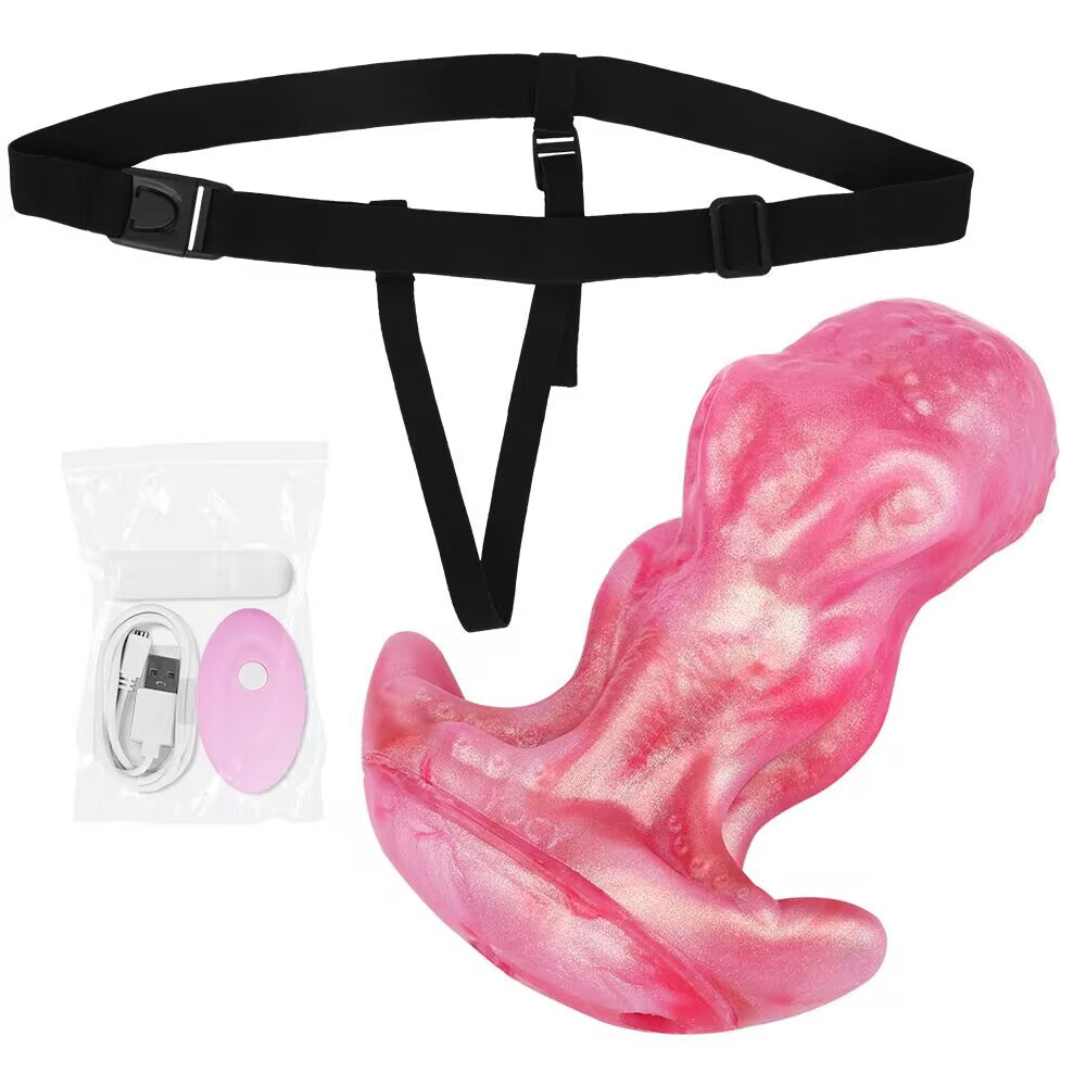 Black wearable strap-on body harness displayed with shimmering pink octopus dildo and remote controller.
