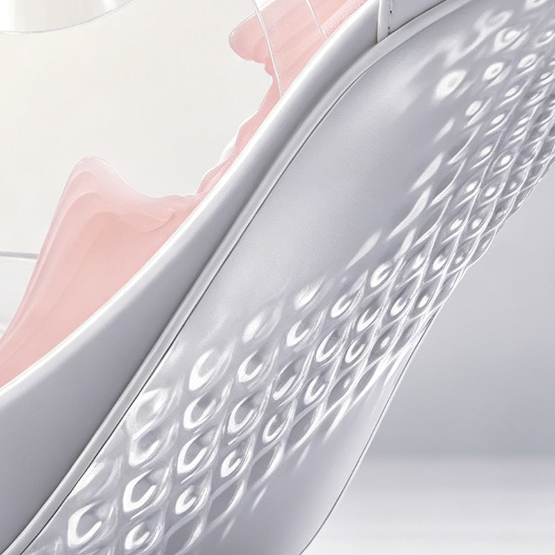 Extreme macro close-up of the durable white outer shell featuring diamond grip texture on the bottom of the high heel stroker cup.